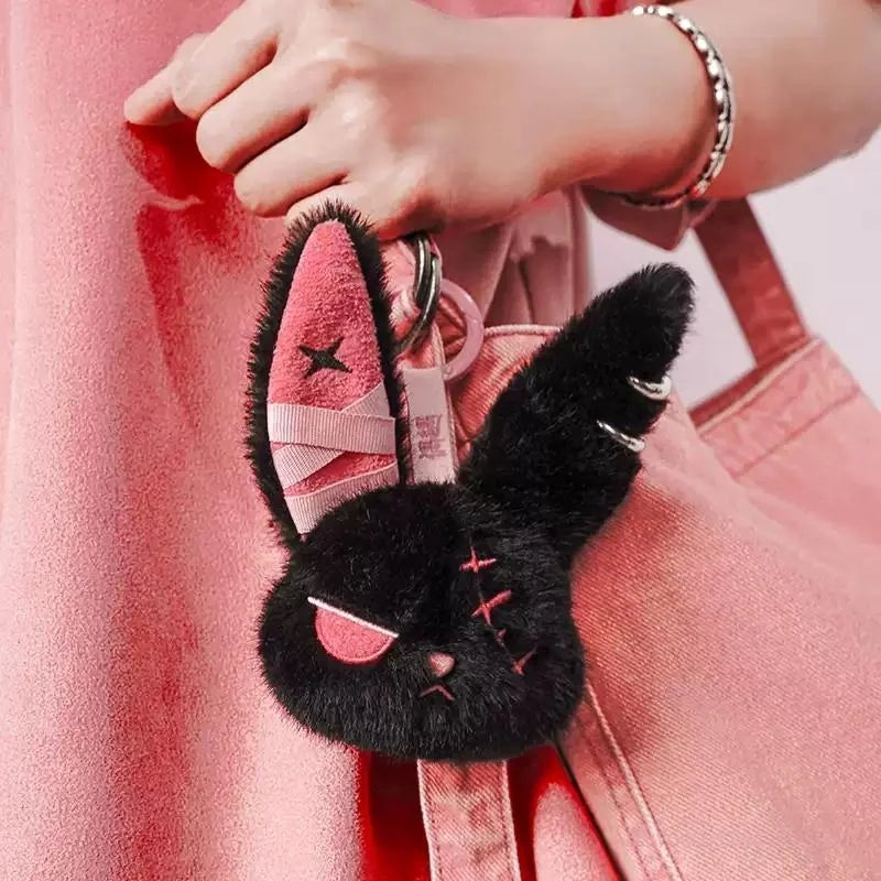 Cuddly Bunny - DarkCute BandaBun keychain attached to a pink bag, showcasing its soft plush design and playful features.