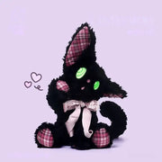 Listening black cat plush toy with expressive mint-green eyes and plaid ears, perfect for gifting.
