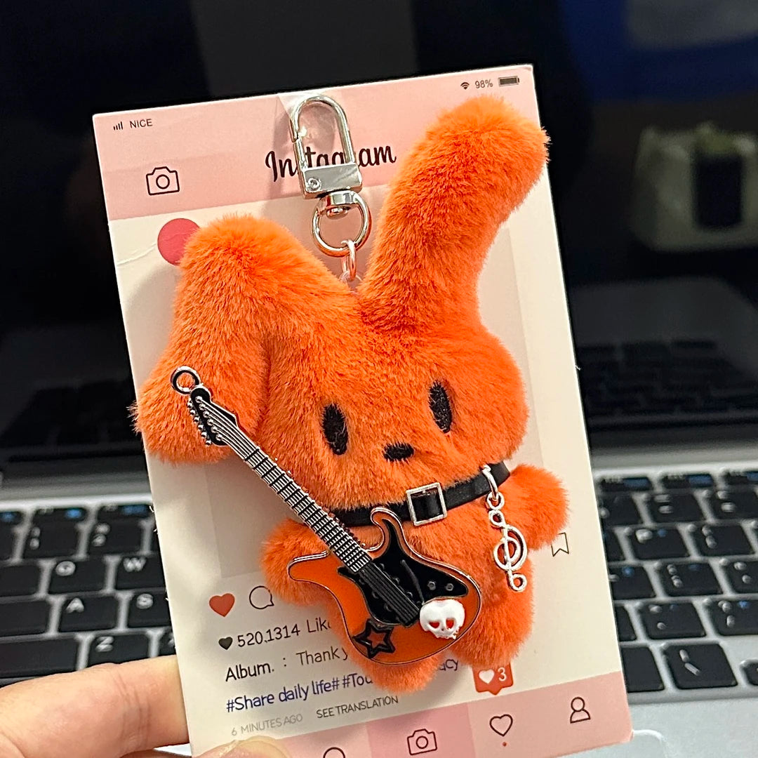 Guitarist Bunny Plush Charm with plush guitar on a social media card, perfect for stylish backpacks.