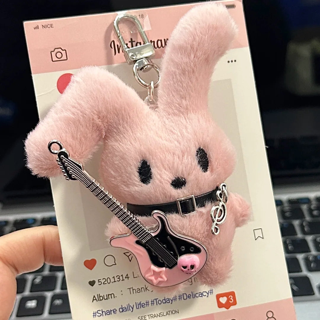 Guitarist Bunny Plush Charm featuring a pink fluffy bunny keychain with a miniature guitar.